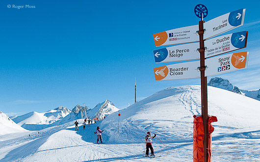 Young skiers and piste signs, Le Grand Bornand