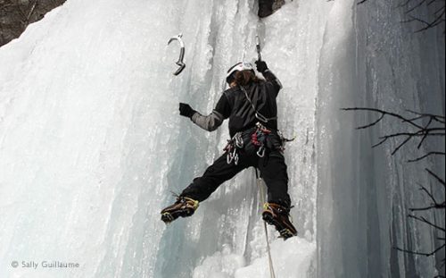 Ice climber on frozen waterfall