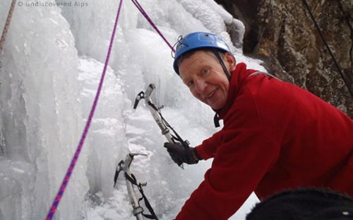 Male ice-climber with equipment detail