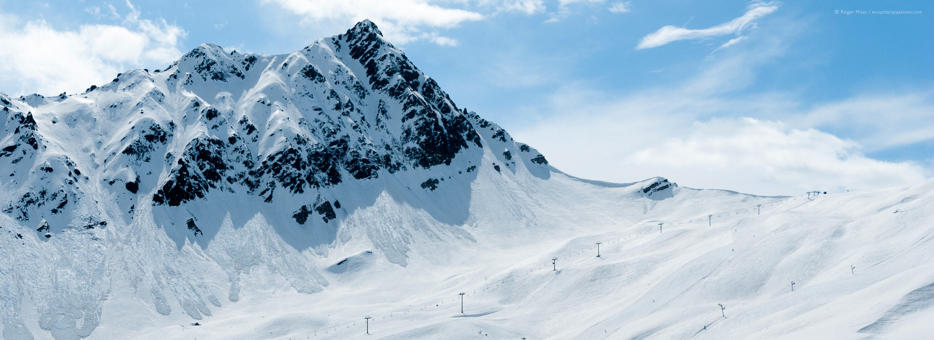 Long view of mountainside with ski lifts at Les Contamines