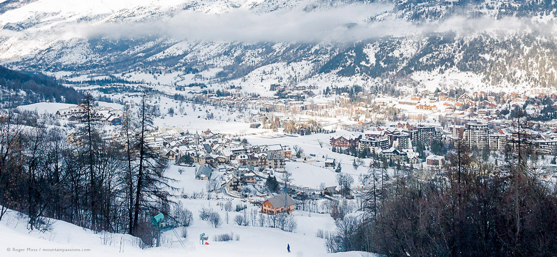 Overview of skier returning to snow-covered valley, showing villages
