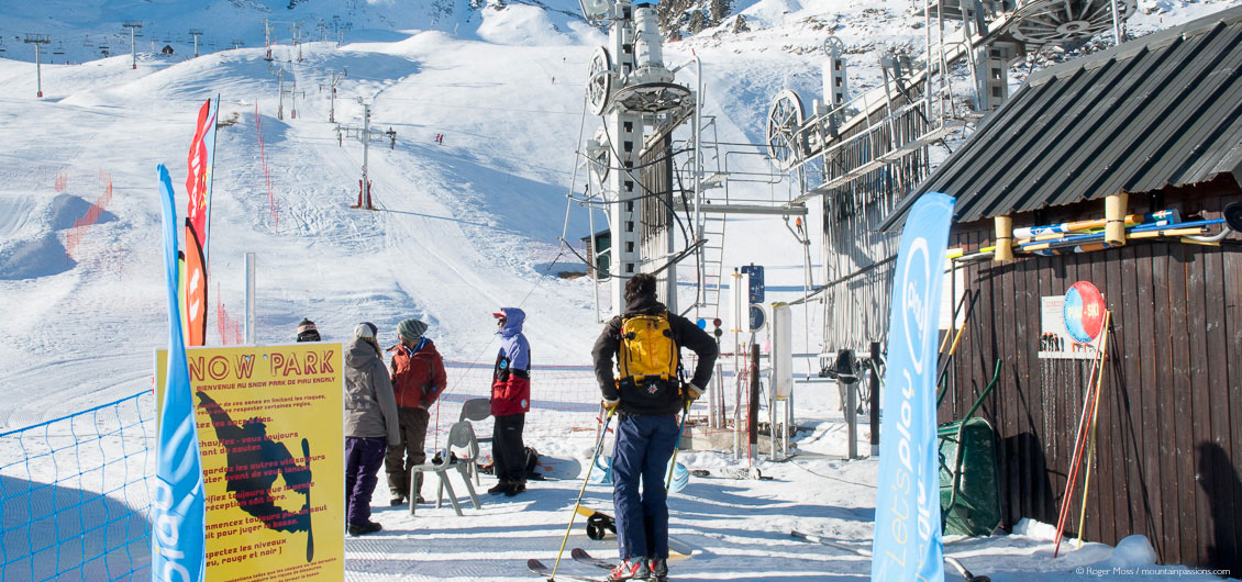 Skiers at drag-lift beside snow park