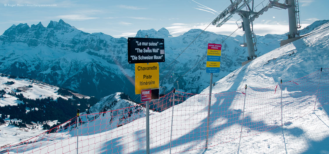 View of mountains with Swiss Wall piste sign and ski-lift at Avoriaz