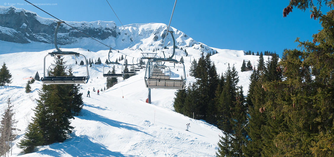 Elevated view from chair-lift of mountainside with skiers at Megeve