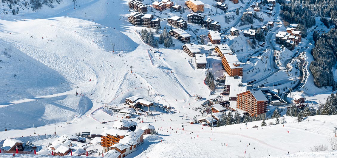 View from the mountainside of skiers at Meribel ski resort, French Alps