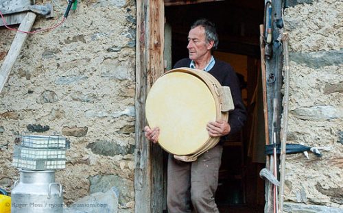 Jean-Pierre Blanc carrying a newly-made Beaufort cheese