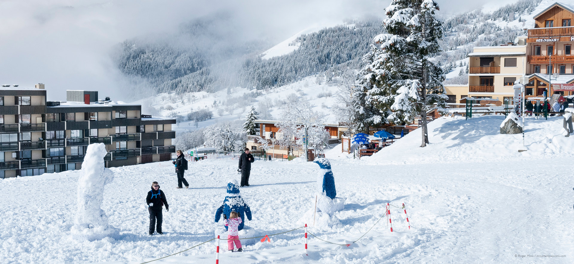 Families enjoying fresh snow at the ski village of Saint-Francois Longchamp.