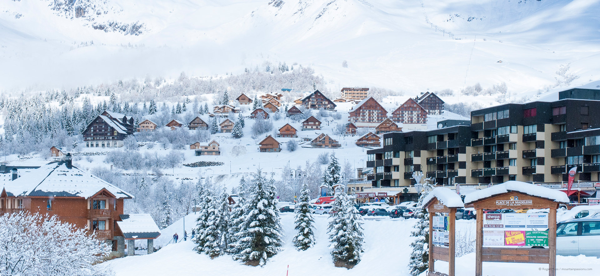 Fresh snow on chalets and trees of ski village of St Francois Longchamp.