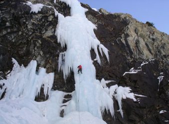 Frozen waterfall with ice climber.