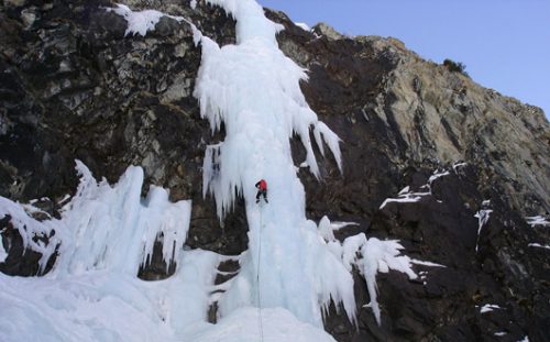 Frozen waterfall with ice climber.