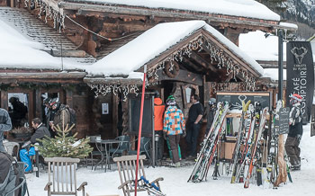Skiers entering Le Comptoir restaurant at Vallorcine ski village, Chamonix Valley, French Alps.