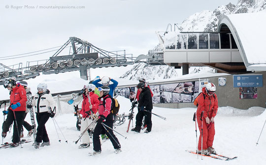 Group of skiers leaving top station of Planpraz gondola ski lift