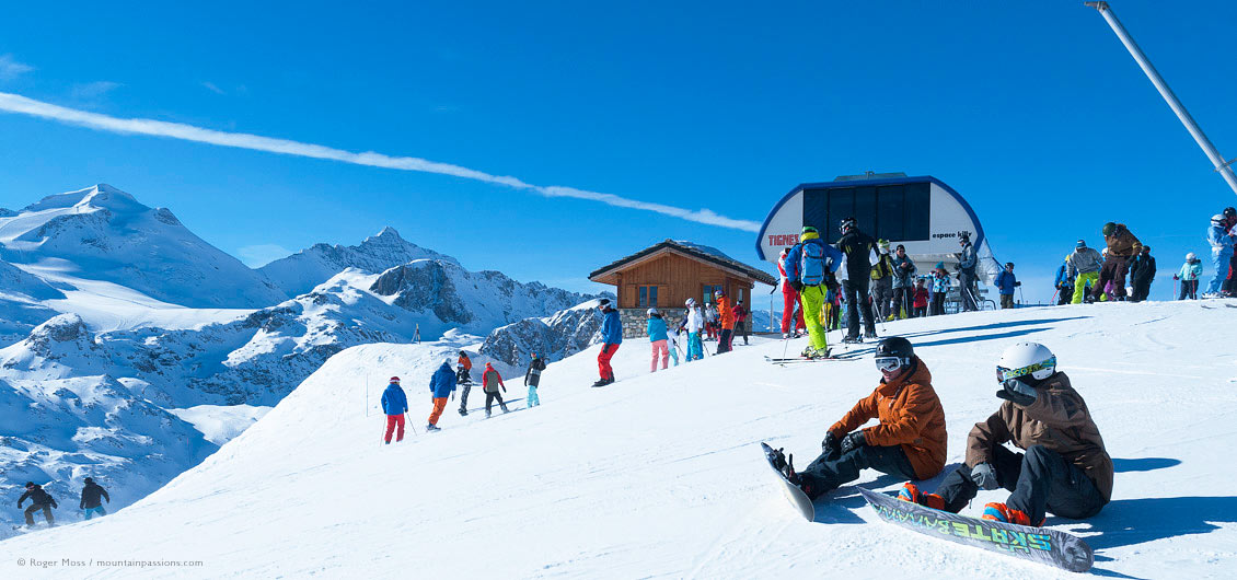 Skiers and snowboarders leaving chair-lift