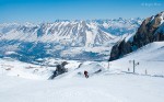 Skiers on piste with mountain views, Le Devoluy, southern French Alps