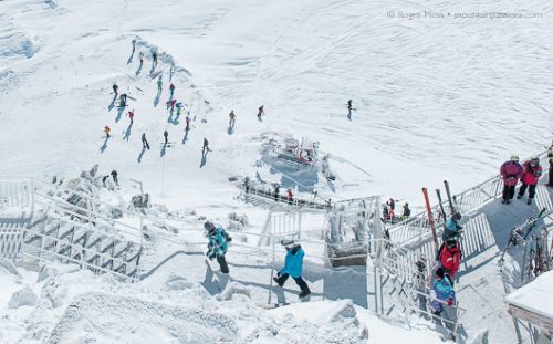 Skiers descend from the Grand Montets cable car, Argentière.