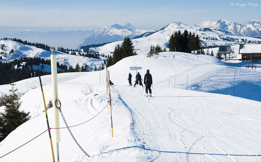 Skiers on Blue-graded pistes at Les Saisies