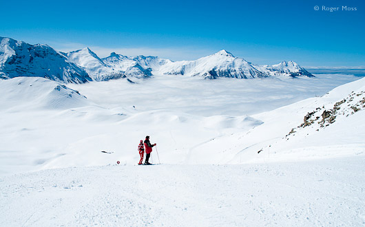 Orcieres, skiers on piste above clouds.