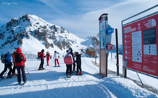 Skiers looking at piste map, Serre Chevalier