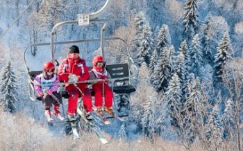 ESF instructor with children on ski lift at Velmeinier, French Alps