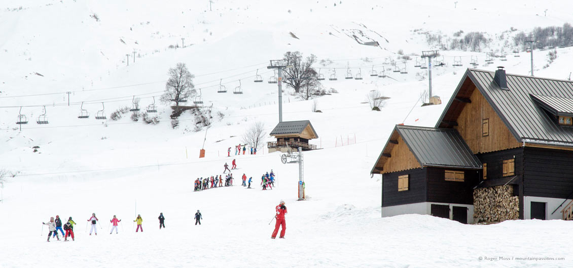 View of children's ski school groups on mountainside