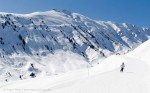 Wide view of skier on piste in valley between La Toussuire and Saint Colomban des Villards, Les Sybelles, French Alps