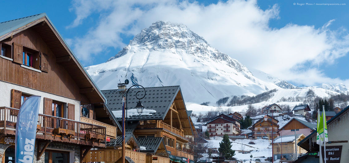 Low view of village centre, with snow-covered mountainside