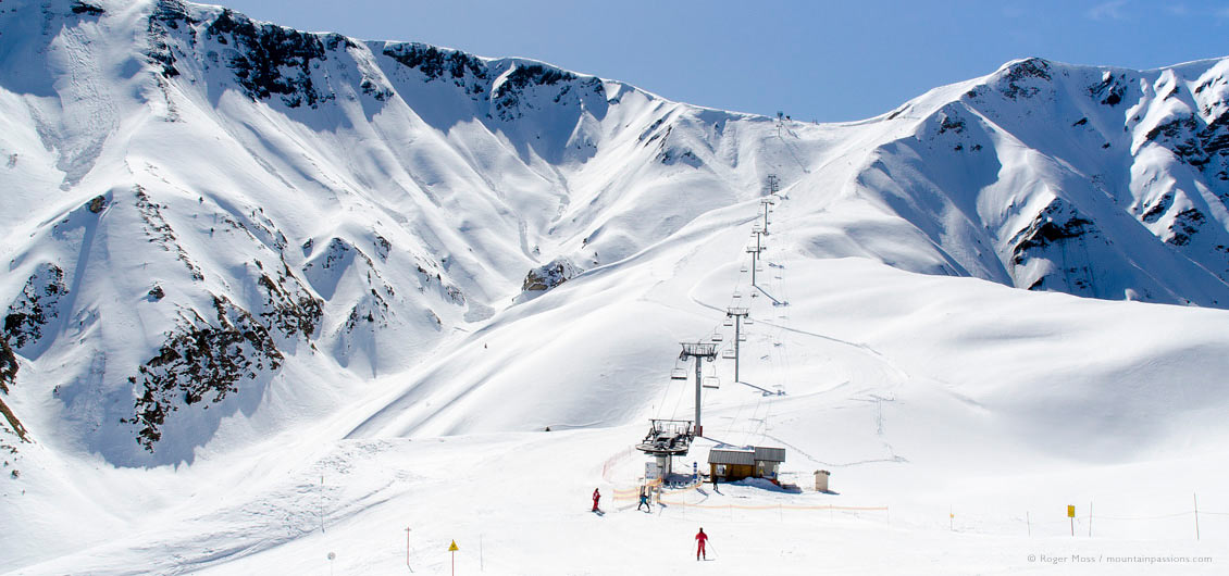 Wide view of skiers reaching chairlift, La Toussuire, Les Sybelles, French Alps