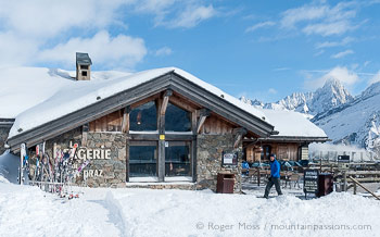 Side view of Bergerie Planpraz mountain restaurant with fresh snow
