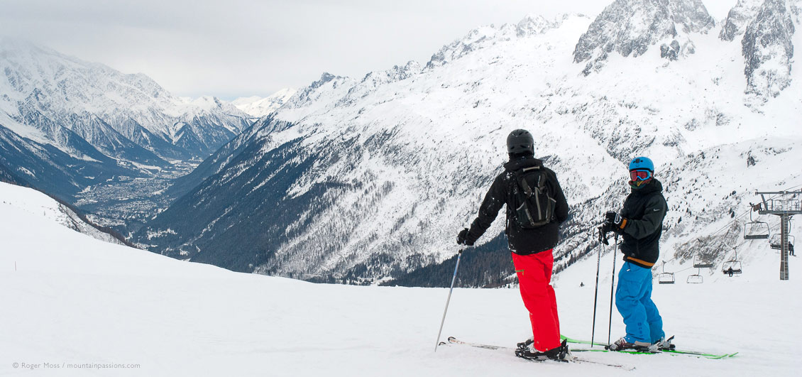 Wide view of two skiers from Vallorcine with overview of Chamonix Valley