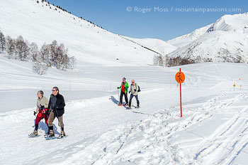 Snow-shoe walkers on marked trail at Les 2 Alpes