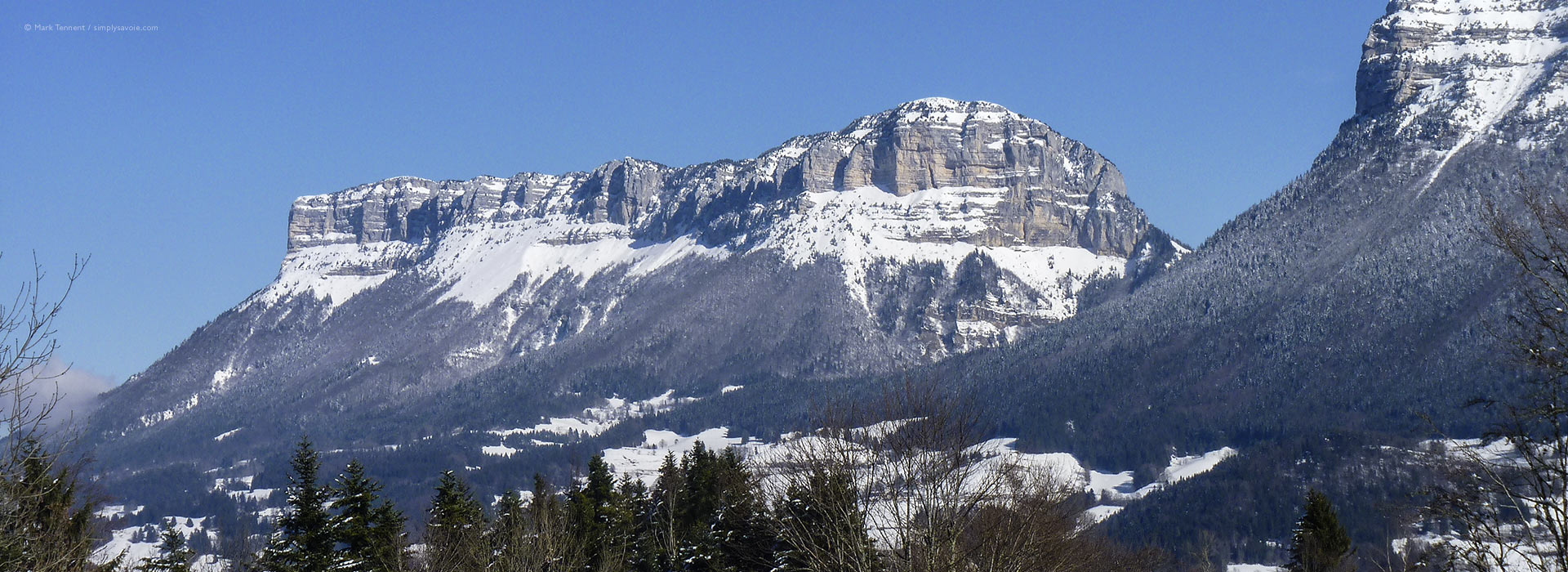 Wide view of snow-covered mountains and valley in Chartreuse Massif