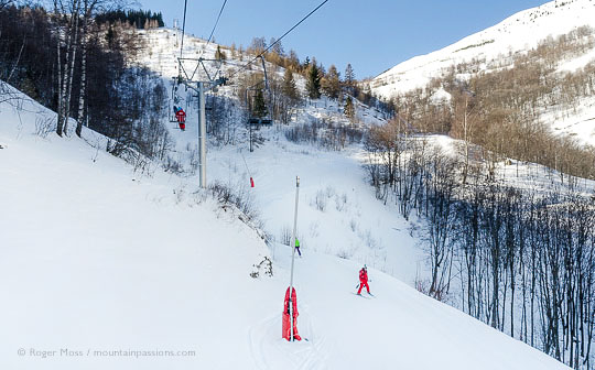 View from chairlift of skier on woodland piste at Les 2 Alpes.