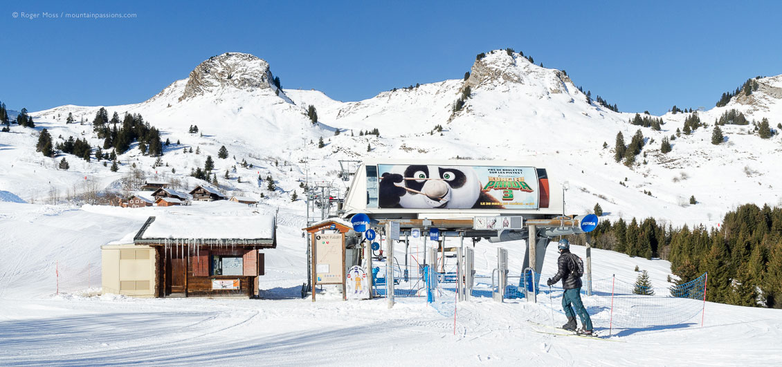 Wide view of skier joining Haut Fleurie chairlift at Praz de Lys, French Alps.