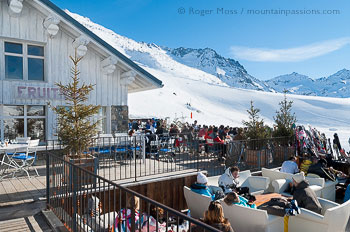 View of skiers relaxing on sun terrance at La Fruiterie, Val Thorens.