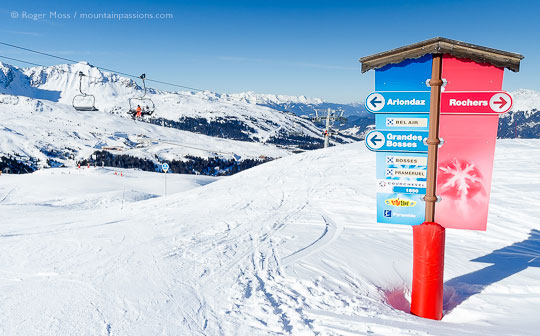 View past ski piste signgage to chair lift at Courchevel Moriond, French Alps.