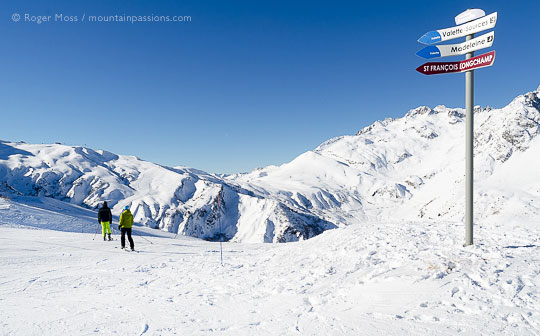 Skiers joining piste above Combe Beaudin, Valmorel, French Alps.
