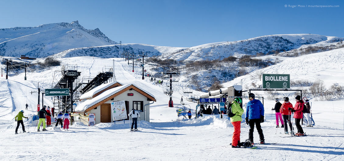 Skiers beside ski lifts on mountainside at Valmorel, Savoie, French Alps