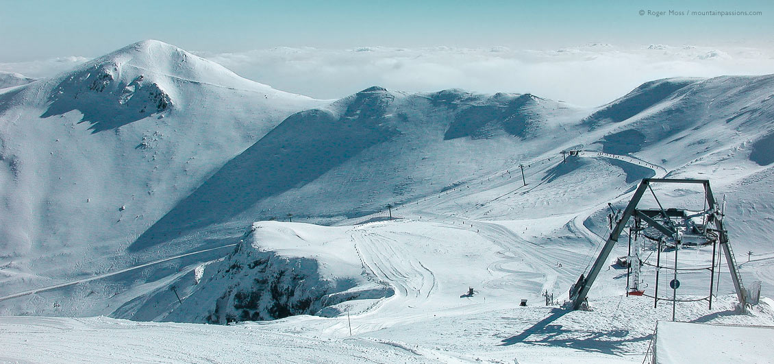 Wide view of ski pistes and draglift at Le Mont Dore, Auvergne, France