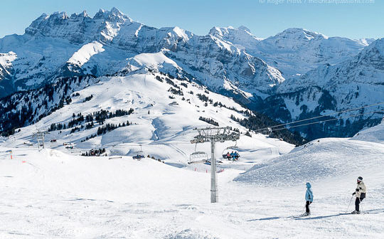 Overview of two skiers descending mountainside at Les Crozets, Portes du Soleil