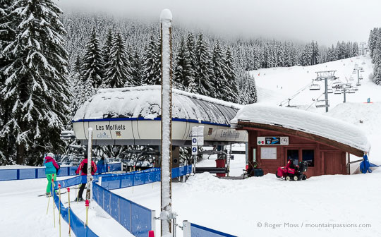 Skiers approaching high-speed chairlift above Les Carroz, French Alps.