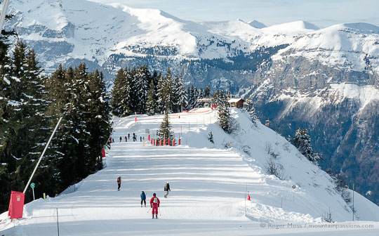 High view of skiers on piste between Samoens and Les Carroz, French Alps.