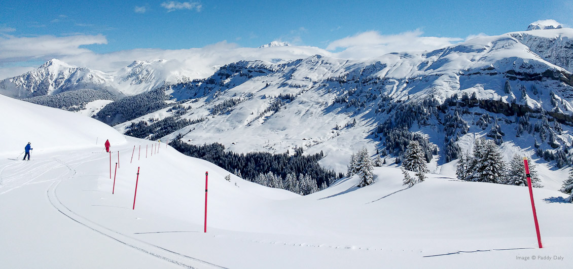 Ski instructor and skier in beautiful mountain setting at Areches-Beaufort, French Alps