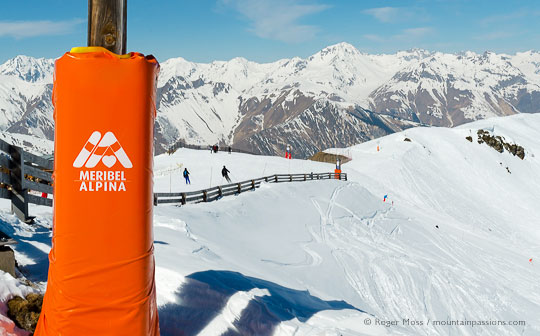 View of two skiers with mountains above Meribel