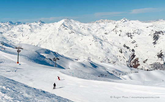 Skier and instructor on wide piste