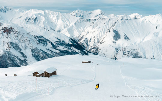 Wide view of lone skier on mountainside