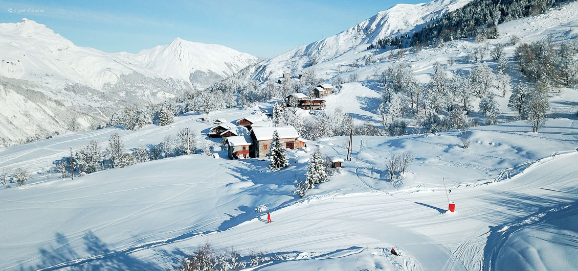 View of snowboarder on ski piste above Saint Martin de Belleville