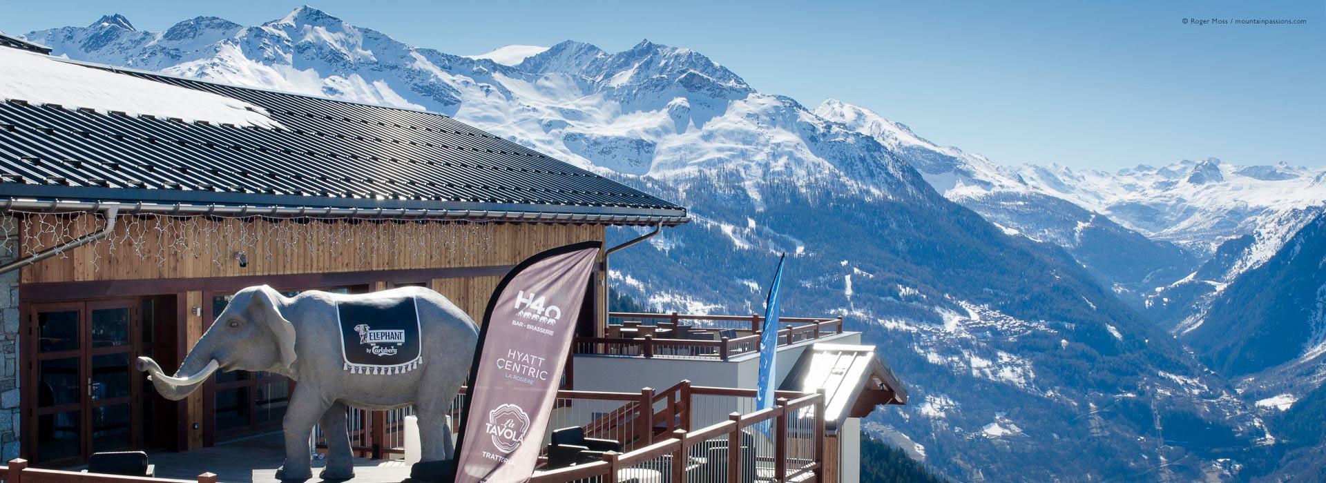 Wide view of Hyatt Centric hotel sun deck with snow-covered mountains