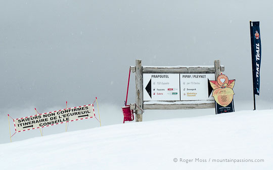 ski piste signs above Prapoutel with falling snow
