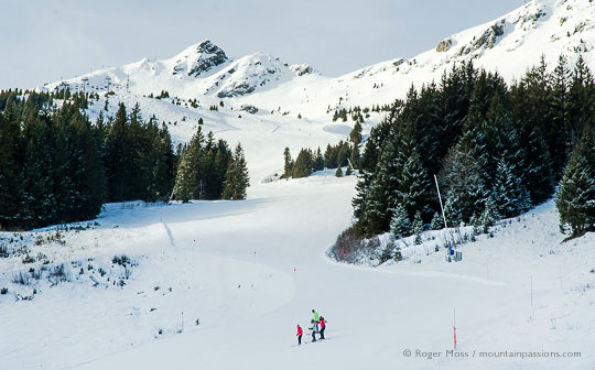 View from chairlift of skiers on mountainside