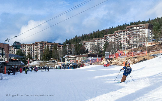 Skier returning to Cote 2000 village